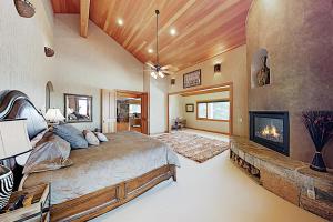 a bedroom with a large bed and a fireplace at Golden Eagle Dreams in Park City