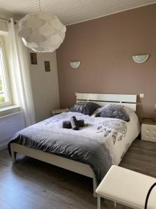 a bedroom with a large bed with a white bedspread at Voie Verte in Cornimont