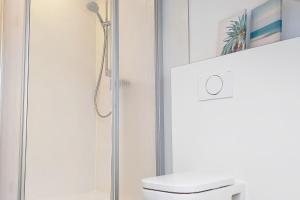 a bathroom with a shower and a toilet at Holiday Apartments Brachttal in Hellstein