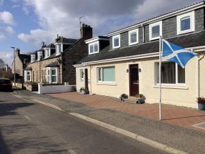 a house with a blue flag in front of it at Silverstrands in Inverness