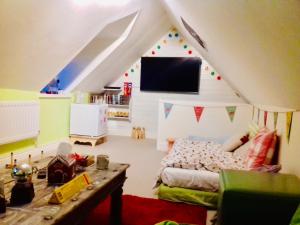 a bedroom with a tent with a bed and a table at Virginia Cottage in Bulwick +11 photos