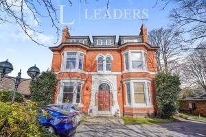 a brick house with a car parked in front of it at Magdala Apartment in Nottingham