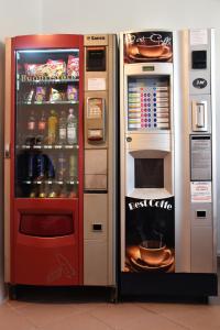 two refrigerators are next to each other with food at Pension Recidency in Oradea