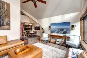 a living room with a couch and a tv at Mountain Village Lodge 351 in Park City