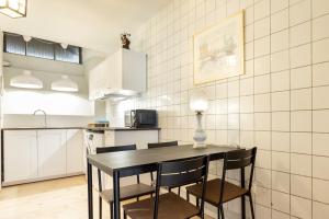 a kitchen with a table, chairs and a microwave at ApartDirect Gamla Stan in Stockholm