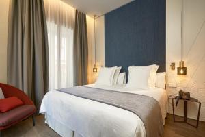 Postel nebo postele na pokoji v ubytování Suites Murillo Plaza Sta. Cruz