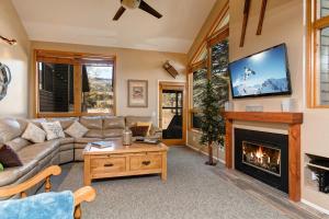 a living room with a couch and a fireplace at Red Pine Condominiums 69 in Park City
