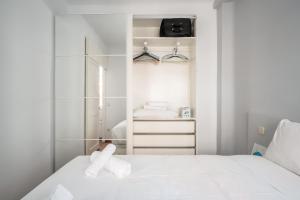a bedroom with a white bed and a closet at 2 bedrooms 1 bathroom furnished - Anton Martin - Vintage - MintyStay in Madrid