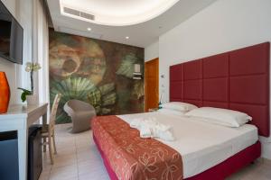 Postel nebo postele na pokoji v ubytování Hotel Stella D'Oro