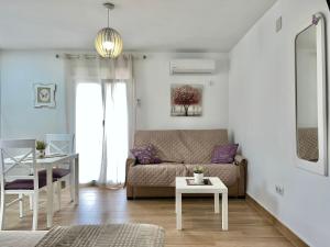 a living room with a couch and a table at APARTAMENTO , LOFT BOBASTRO CErCA DEL CAMINITO DEL REY ARDALES in Ardales