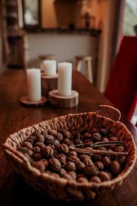 a bowl of coffee beans on a table with candles at La tanière Dinant in Dinant