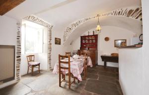 a dining room with a table and a piano at Beautiful Home In Peyremale With 3 Bedrooms in Bordezac