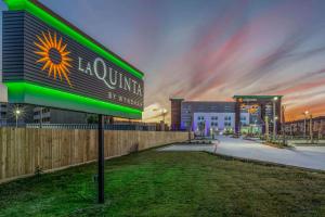 a building with a sunflower sign in front of it at La Quinta Inn & Suites by Wyndham Galveston West Seawall in Galveston