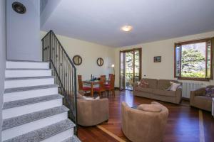 a living room with a staircase and a living room at Residenza Regina in Laglio