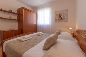 a bedroom with a large bed with towels on it at SEA VIEW- spacious apartment with shared pool in Split