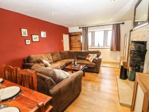 a living room with a couch and a fireplace at Rake Hey Farm in Todmorden