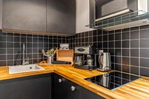 a kitchen with a sink and a counter top at BE YOU LUXURY APART'HÔTEL Paris in Paris