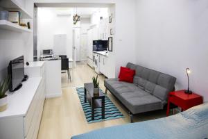 a living room with a couch and a kitchen at OAZU downtown flat in Budapest