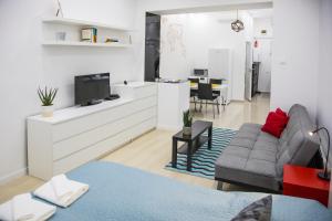 a living room with a couch and a tv at OAZU downtown flat in Budapest