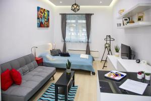a living room with a couch and a table at OAZU downtown flat in Budapest