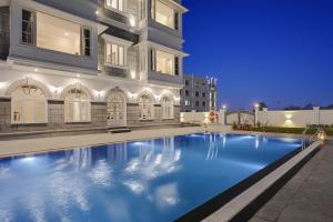 a swimming pool in front of a building at night at Boheda Manor - Luxury Retreat in Udaipur