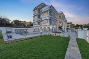 a large house with a lawn in front of it at Boheda Manor - Luxury Retreat in Udaipur