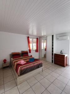 a bedroom with a large bed in a white room at Haut de Villa chez Ghighi in Abondance