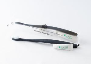 a toothbrush and a toothpaste tube on a white background at APA Hotel Nambaminami Ebisucho Eki Shinsekai in Osaka