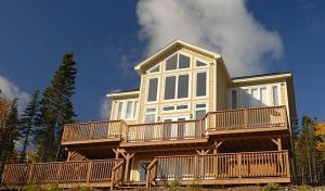 a large house with a large deck on top of it at The Thoughtful Dog Bed & Breakfast in South Brook