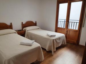 Ένα ή περισσότερα κρεβάτια σε δωμάτιο στο Hostal Apolo XI