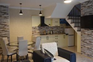 a kitchen and living room with a table and chairs at ELEANA in Borjomi