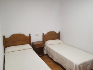 Ένα ή περισσότερα κρεβάτια σε δωμάτιο στο Hostal Apolo XI