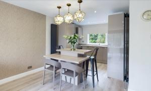 a kitchen and dining room with a table and chairs at Inviting 2-Bed House in Newcastle upon Tyne in Newcastle upon Tyne