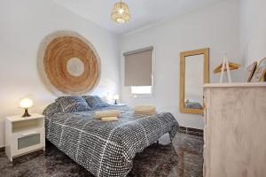 a bedroom with a bed and a mirror at El Cotillo Mar Sea View in Cotillo