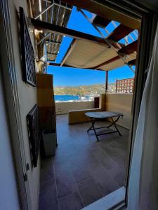 a balcony with a table and a view of the ocean at Infinity view - Few steps away from the sea. in Agia Pelagia