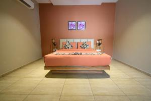 a bedroom with a bed and two pictures on the wall at The Sky Imperial Bapu's Resort in Dwarka