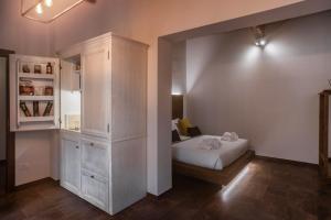 a bedroom with a bed and a large cabinet at Oro Nero Florence in Florence