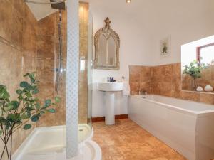 a bathroom with a shower and a tub and a sink at Hope Cottage in Bakewell +24 photos