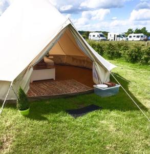 a tent sitting in the grass in a field at Wold Farm Bell Tents in Flamborough