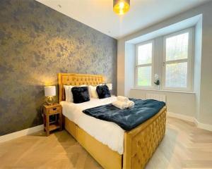 a bedroom with a large bed and a window at Trendy and Newly Reno'd 1 Bed Nr The Meadows in Edinburgh