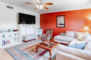 uma sala de estar com um sofá e uma televisão em Jupiter Coyote em Tucson