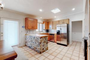 a kitchen with a stone island in the middle at Jupiter Coyote in Tucson