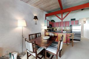 a kitchen with a wooden table and chairs and a refrigerator at Sierra Del Sol 6 in Taos Ski Valley