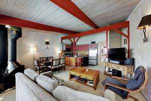 a living room with a couch and a fireplace at Sierra Del Sol 6 in Taos Ski Valley