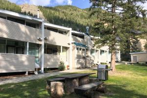 a building with a picnic table in the yard at Sierra Del Sol 6 in Taos Ski Valley