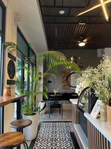 a restaurant with a table and chairs and plants at Sóc Nhím Homestay in Phu Quoc