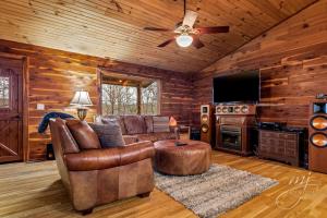 a living room with a couch and a ceiling fan at Fly Away Cabin- Modern, Serene, And Convenient in Compton