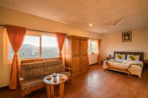 
a living room filled with furniture and a window at Winter Vale Green Stay Resorts in Vagamon
