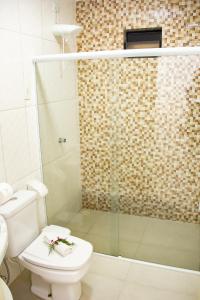 uma casa de banho com um WC e um chuveiro em Pousada Polymar em Maragogi