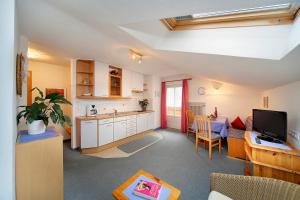 a kitchen and a living room with a dining room at Haus Bernhard in Schenna